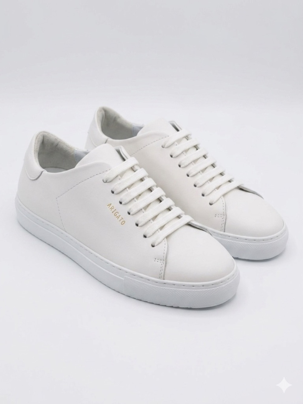 Axel Arigato Women’s White Leather Low-Top Sneaker with Gold Branding